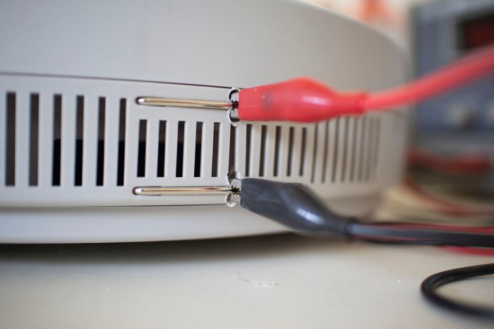 Neato charging experiments drilled holes around contacts for alligator clips